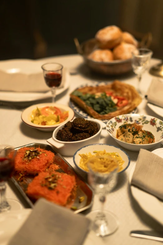 a table that has a lot of food on it, a digital rendering, unsplash, renaissance, salmon khoshroo, holiday, greek ameera al taweel, at a dinner table