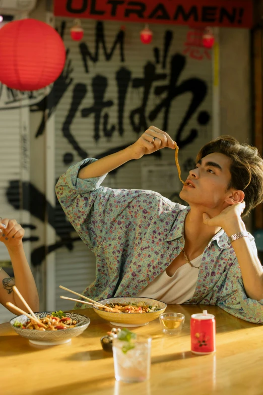 two people sitting at a table eating food, a picture, inspired by Chen Hong, trending on pexels, beautiful boy, his hair is messy and wild, kung fu, male model