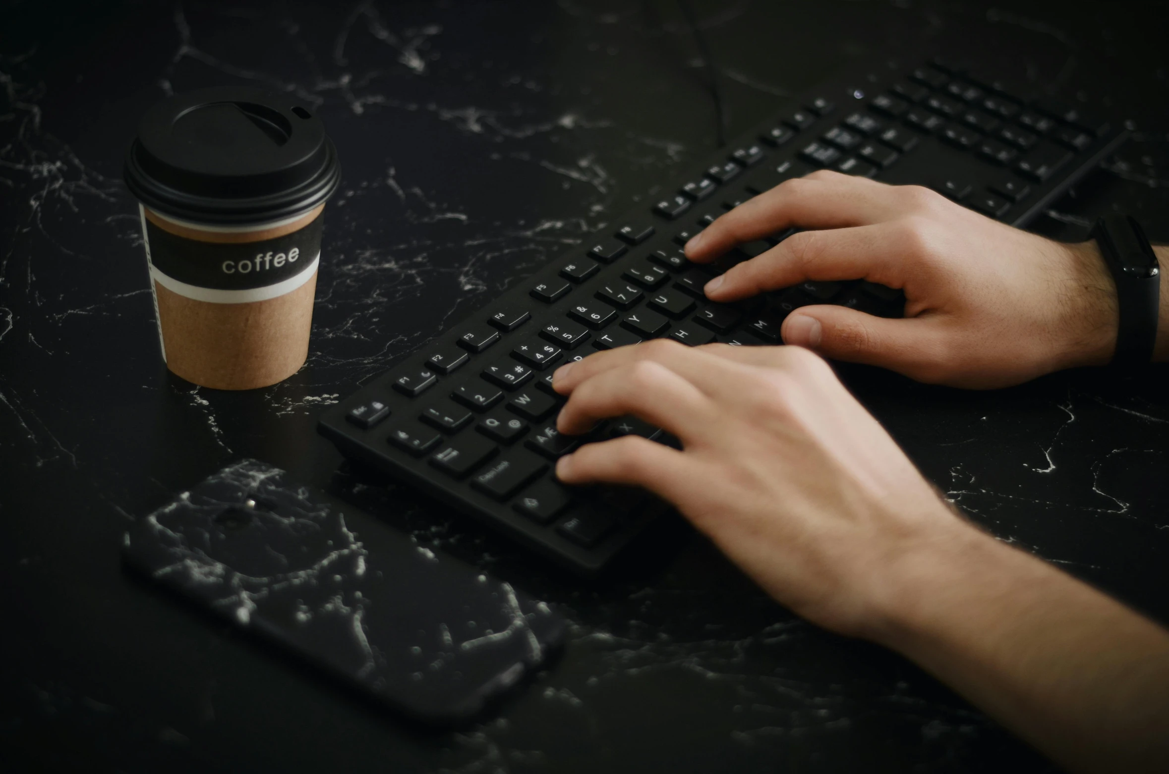 a person typing on a keyboard next to a cup of coffee, gritty tech, mmo, thumbnail, ignant