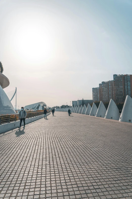 a man sitting on a bench talking on a cell phone, an album cover, inspired by Zha Shibiao, trending on unsplash, hypermodernism, santiago calatrava, panoramic view, shipyard, walking to the right