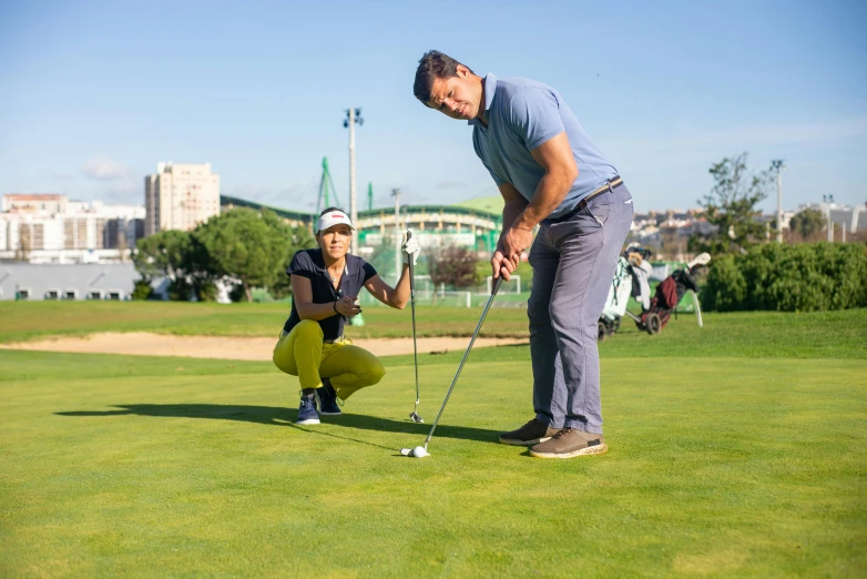 a man and a woman playing a game of golf, pexels contest winner, standing in midground, infested with pitch green, avatar image, city park