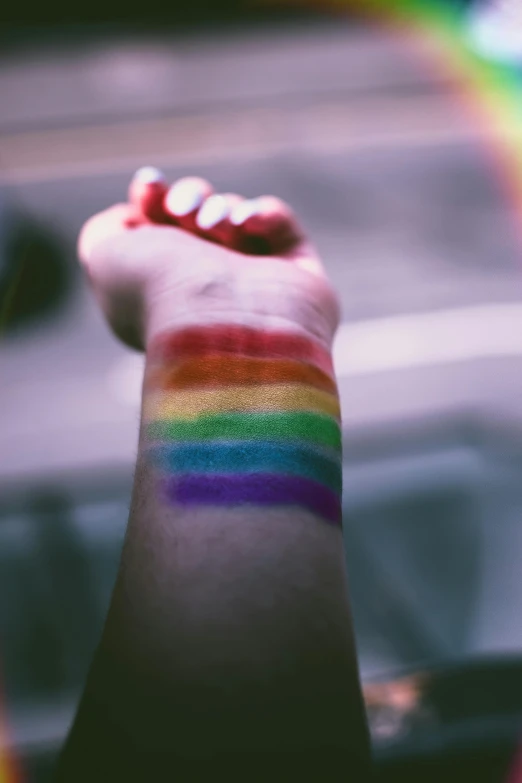 a person's arm with a rainbow painted on it, trending on pexels, lipstick, diverse, colorful signs, dark hues