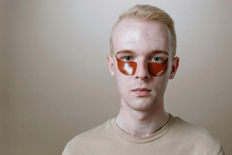 a man with a pair of eye patches on his face, trending on pexels, albino white pale skin, wearing translucent sheet, lean man with light tan skin, smooth red skin