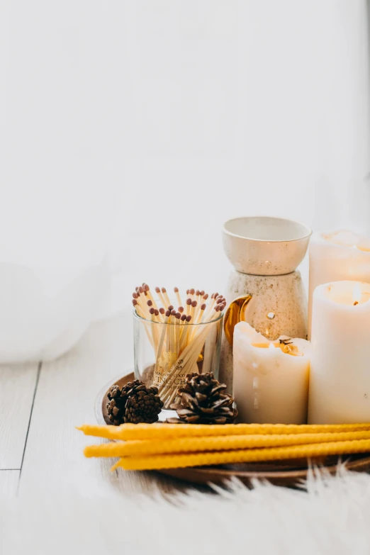 a bunch of candles sitting on top of a table, skincare, multiple details, white bg, fall season