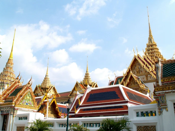 a group of people standing in front of a building, thai architecture, from the distance, royal jewels, roofs
