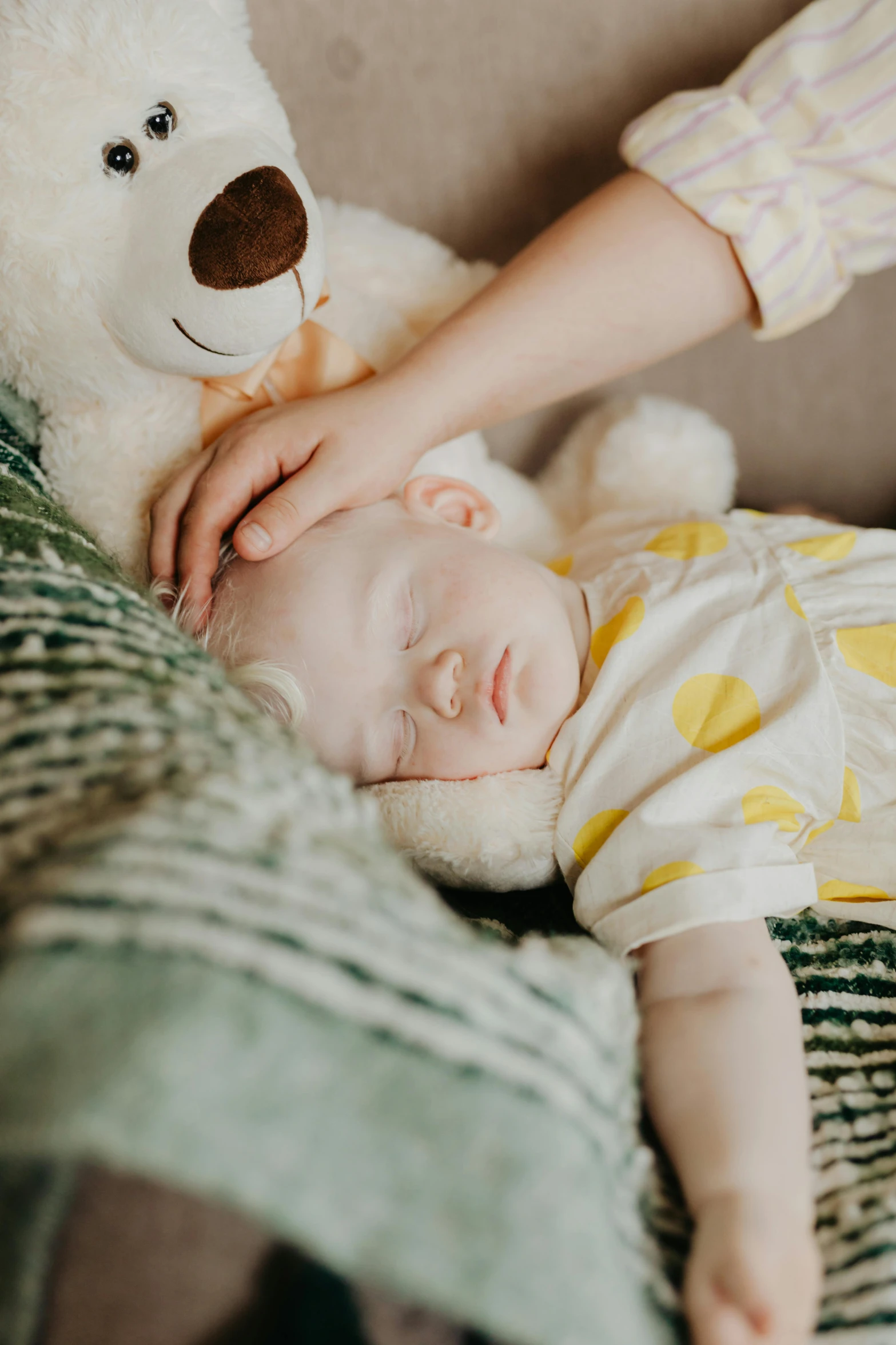 a baby laying in a basket next to a teddy bear, pexels contest winner, he holds her while she sleeps, albino white pale skin, relaxing on a couch, eyes closed