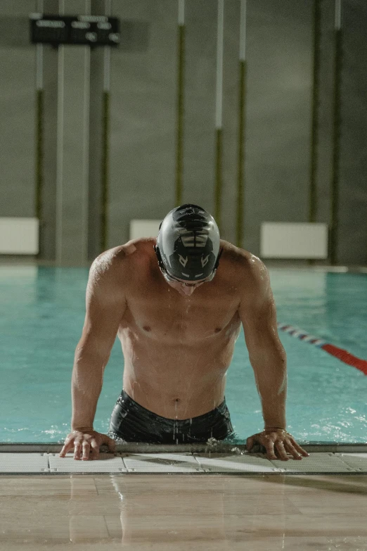 a man standing at the edge of a swimming pool, defined muscles, helmet is off, promo image, light and dark