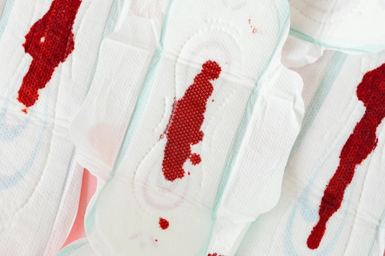 a bunch of cloth pads with blood on them, an album cover, trending on pexels, detail shot, made of lab tissue, detailed product image, obi strip