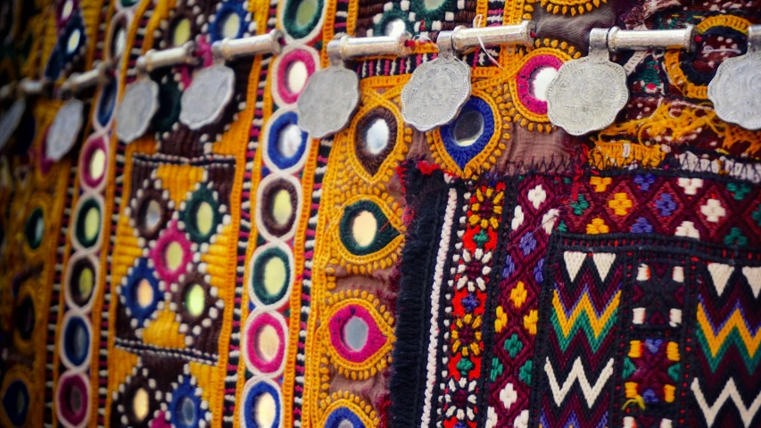 a close up of a bunch of different colored fabrics, trending on unsplash, folk art, oman, wearing many medallions, instagram photo, performance