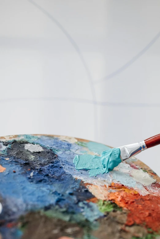 a close up of an artist's palette with a brush, inspired by artist, trending on pexels, analytical art, on grey background, blue and orange palette, 4k photograph of painting, teal palette