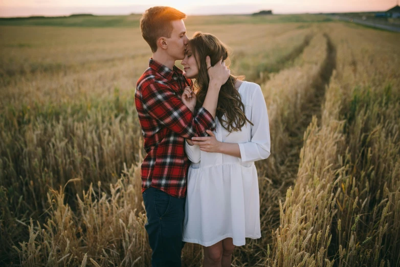 a couple kissing in a wheat field at sunset, pexels contest winner, handsome girl, owen klatte, confident looking, white