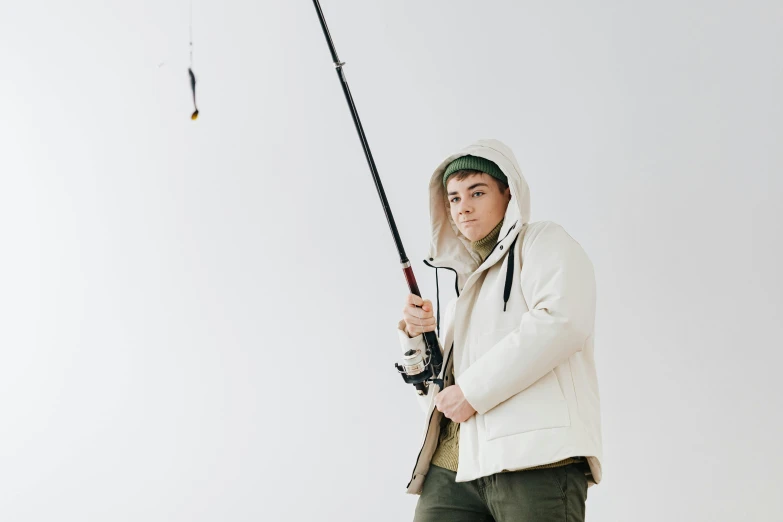 a man in a white jacket holding a fishing rod, trending on pexels, pete davidson, lachlan bailey, studio picture, structure : kyle lambert