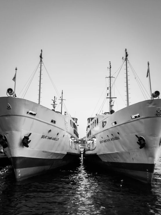 a couple of boats that are sitting in the water, a black and white photo, by Sebastian Spreng, water surrounds the ship, commercially ready, they are close to each other, look at the details