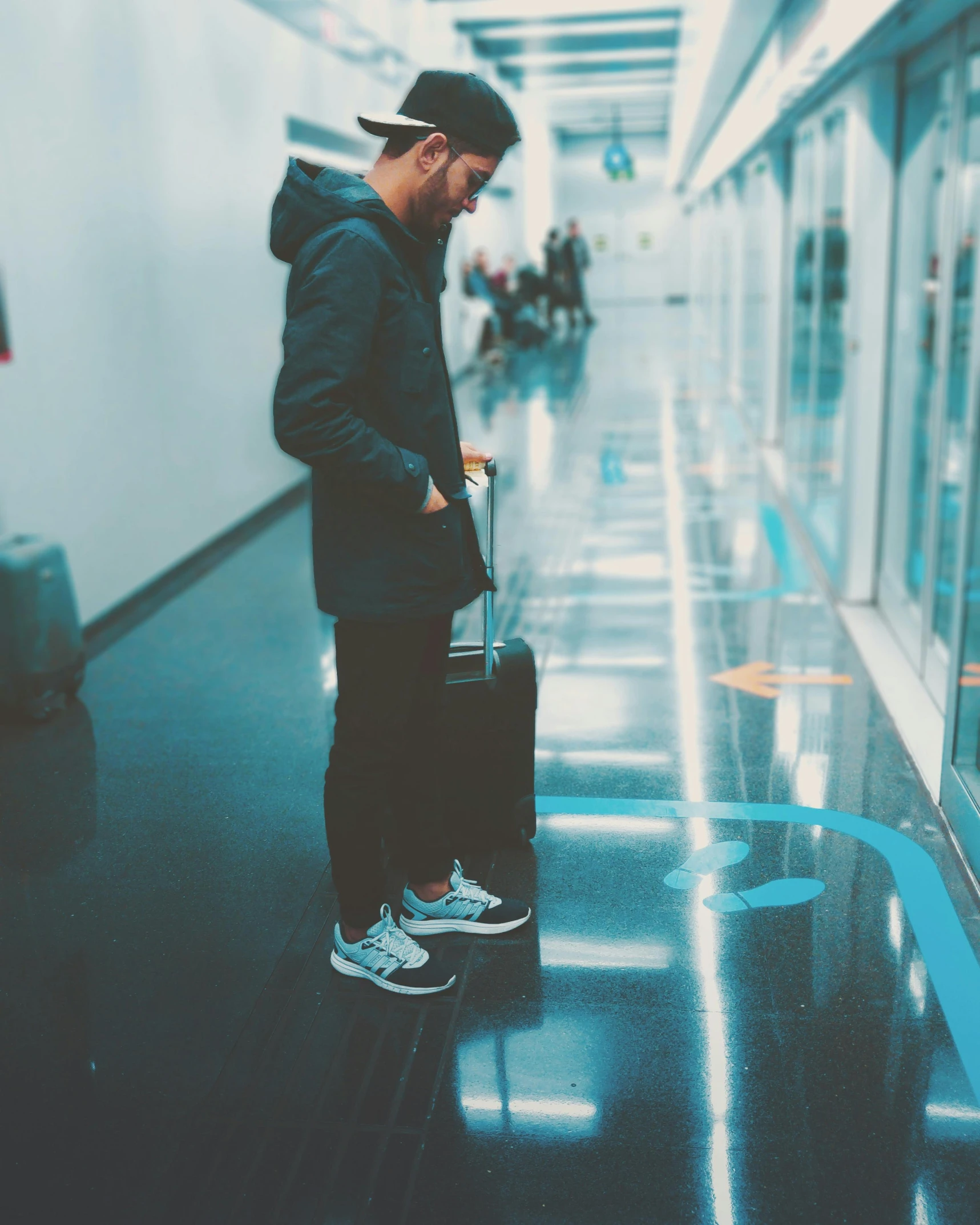 a man standing in a hallway with a suitcase, by Cosmo Alexander, pexels contest winner, happening, lgbt, black. airports, 🚿🗝📝, profile image