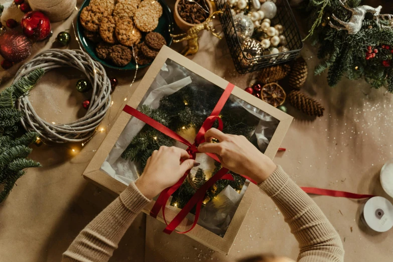 a woman opening a christmas present on a table, pexels contest winner, arts and crafts movement, cereal box, avatar image, ribbon, 🦩🪐🐞👩🏻🦳