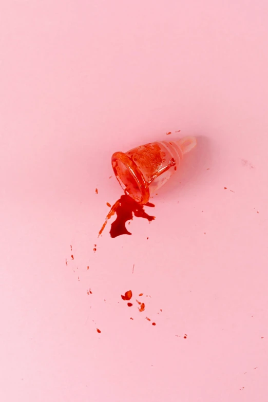a spilled bottle sitting on top of a pink surface, by Doug Ohlson, trending on pexels, bloody scene, cone shaped, ignant, ryan mcginley