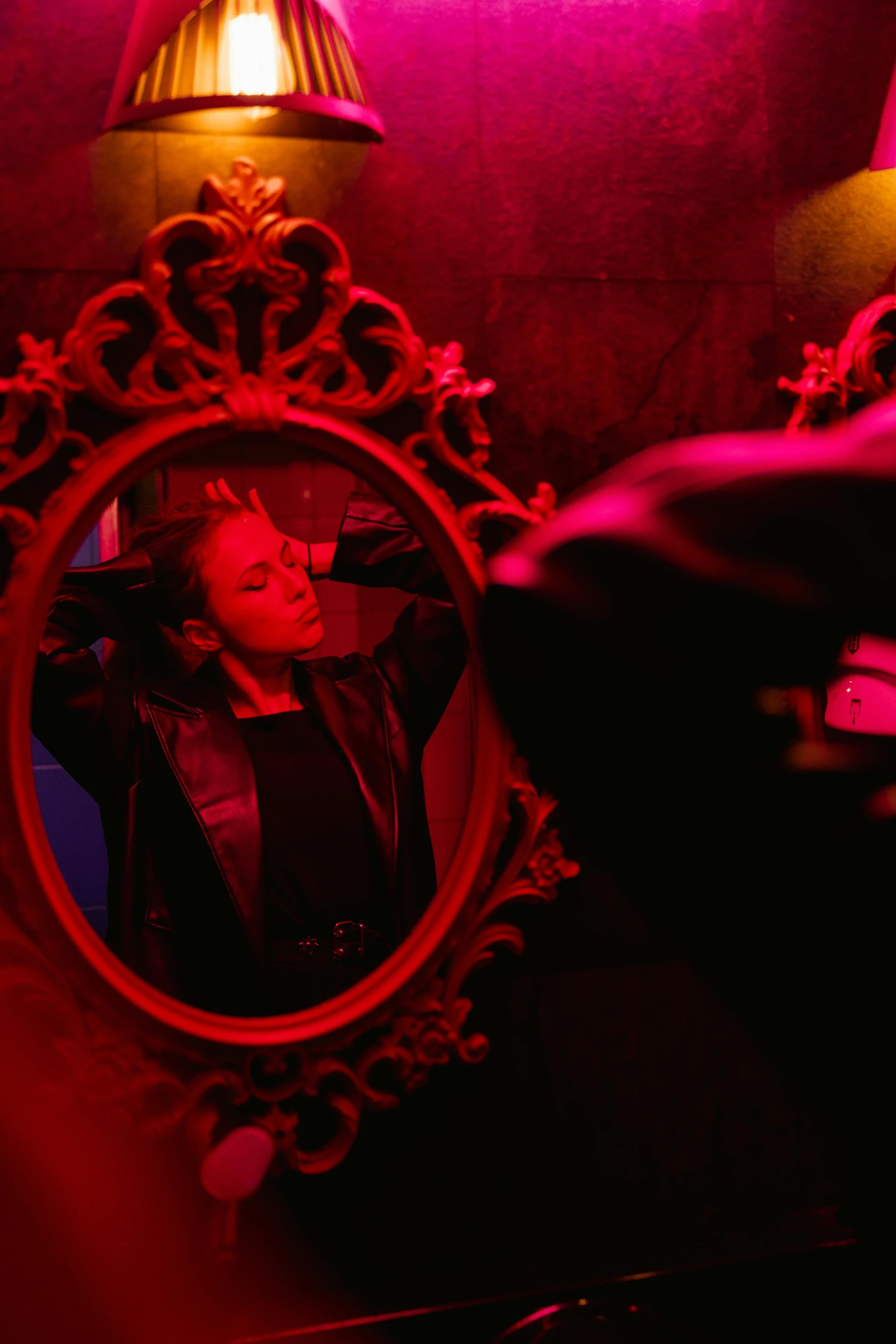 a person taking a picture of themselves in a mirror, by Julia Pishtar, pexels contest winner, renaissance, dramatic red scary lighting, saturday night in a saloon, black light, androgynous vampire