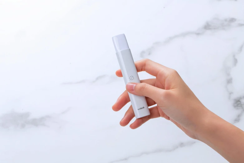 a close up of a person holding a cell phone, inspired by Okada Hanko, tachisme, light grey mist, holding a small vape, matte white paint, detailed product shot