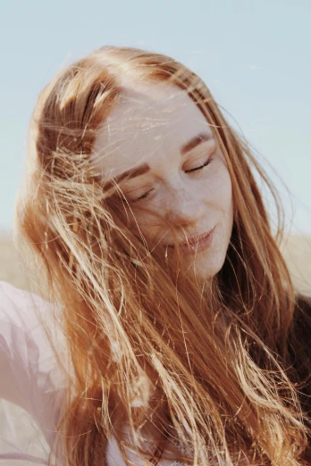 a woman taking a selfie with her cell phone, an album cover, by Grace Clements, trending on pexels, long ginger hair windy, saoirse ronan, lovely delicate face, sun - drenched