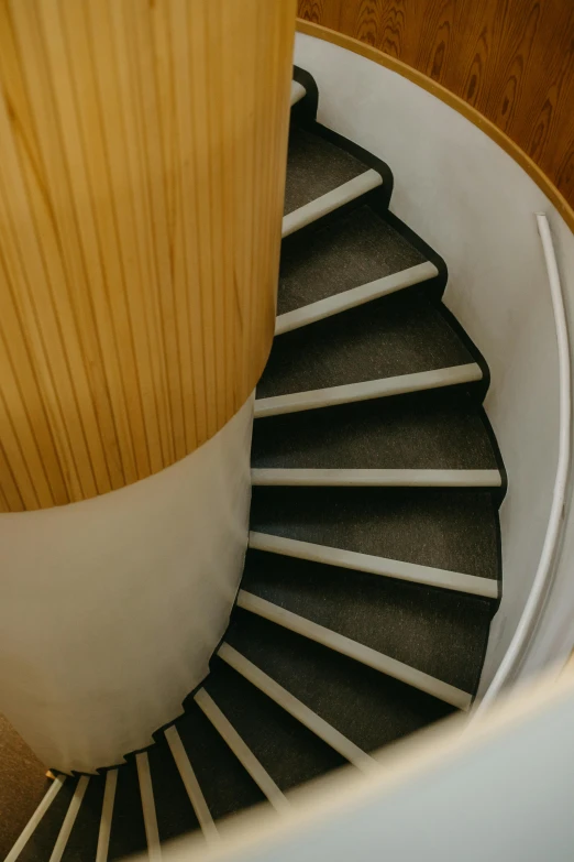 a close up of a spiral staircase in a house, by Doug Ohlson, trending on unsplash, modernism, high - angle view, louis kahn, slate, a blond