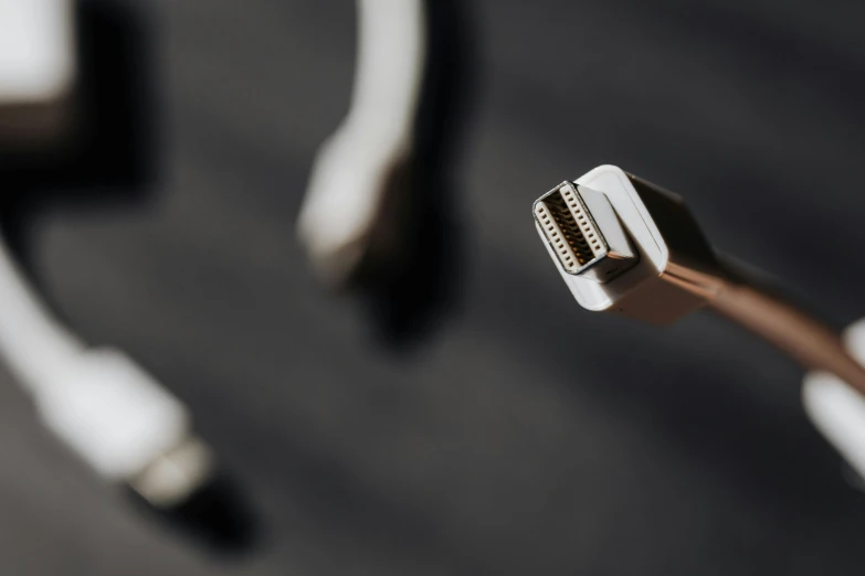 a couple of toothbrushes sitting on top of a table, a macro photograph, by Romain brook, unsplash, minimalism, cables and monitors, white mechanical details, close-up shot from behind, cables on her body