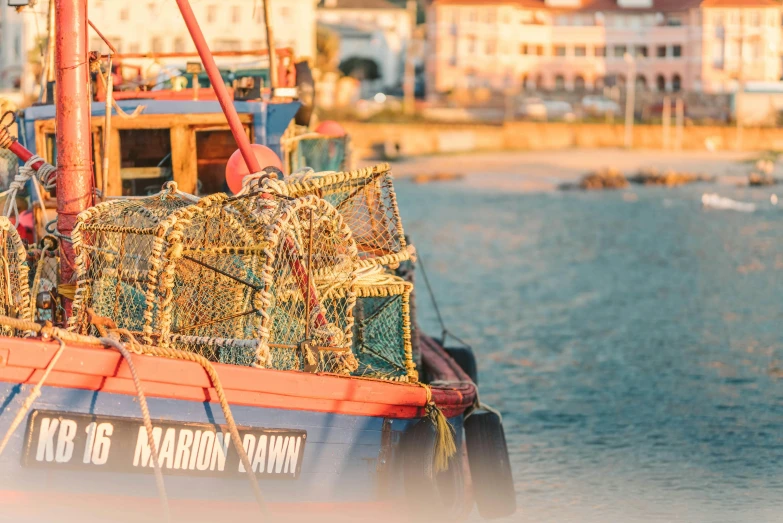 a red and blue boat sitting on top of a body of water, by Simon Marmion, pexels contest winner, fine art, fish seafood markets, golden hour light, south african coast, avatar image