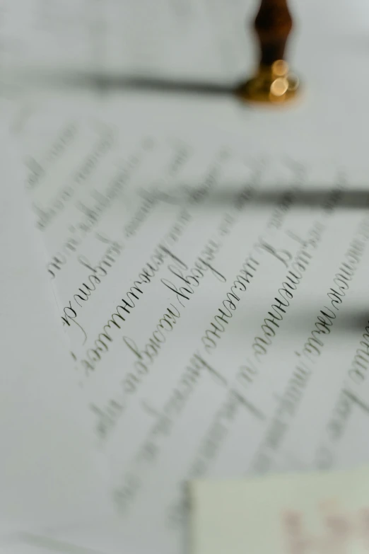 a pair of scissors sitting on top of a piece of paper, intricate writing, taken with sony alpha 9, best photo, tall