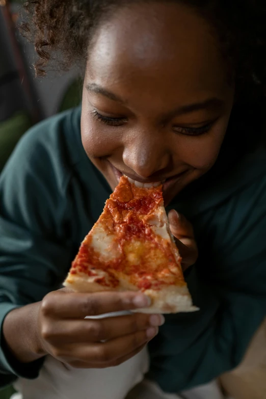 a close up of a person eating a slice of pizza, profile image, aida muluneh, large)}], kids