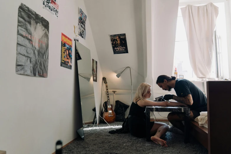 a man and a woman sitting at a table in a room, a tattoo, arbeitsrat für kunst, ultrastation hq, profile image, inside a cozy apartment, maintenance photo