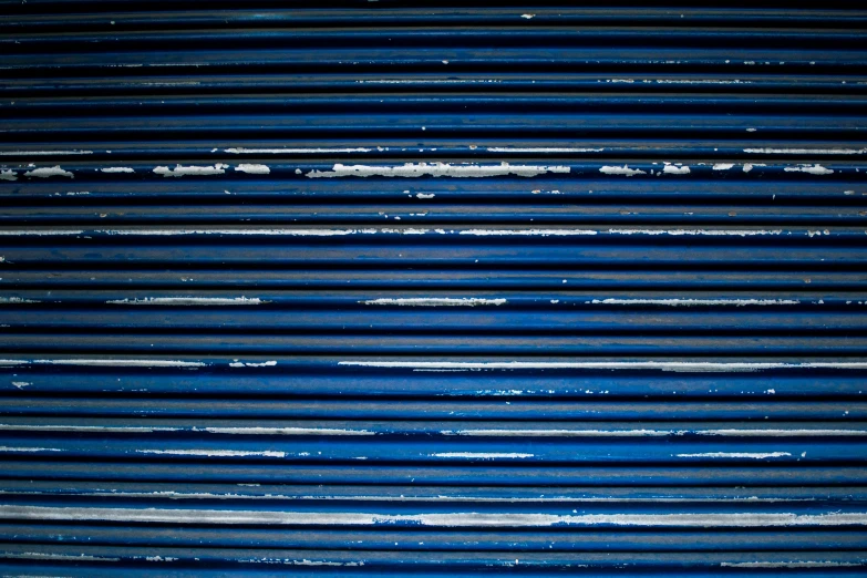 a close up of a blue corrugated wall, inspired by Andreas Gursky, unsplash, graffiti, square lines, radiator, shack close up, deep dark blue