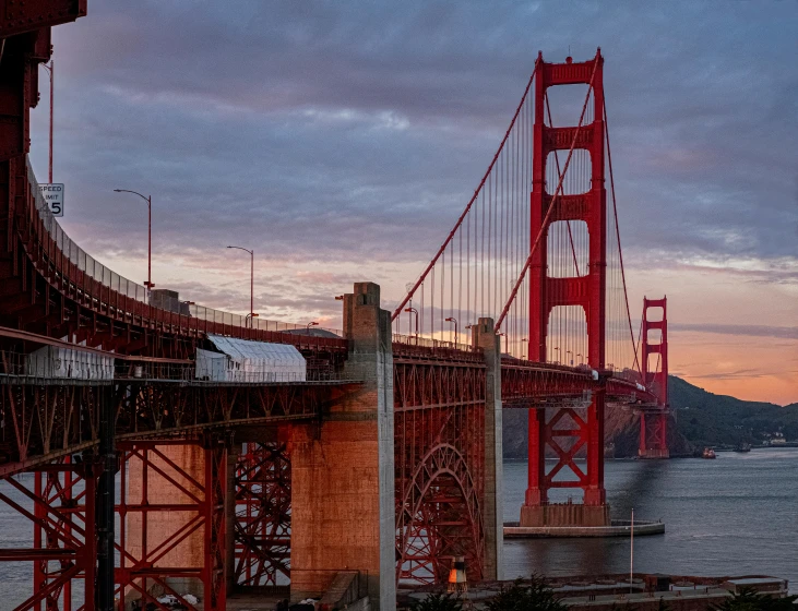 a view of the golden gate bridge at sunset, a picture, by Brian Thomas, pexels contest winner, hyper - detailed color photo, urban surroundings, pink arches, 2022 photograph