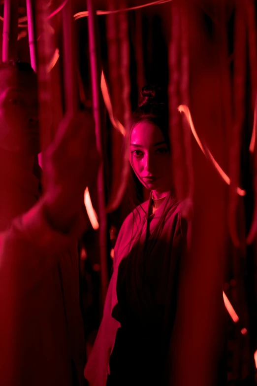 a man standing in front of a red light, inspired by Li Di, pexels contest winner, gutai group, red magic surrounds her, inside her temple, ( ( theatrical ) ), lee madgwick & liam wong