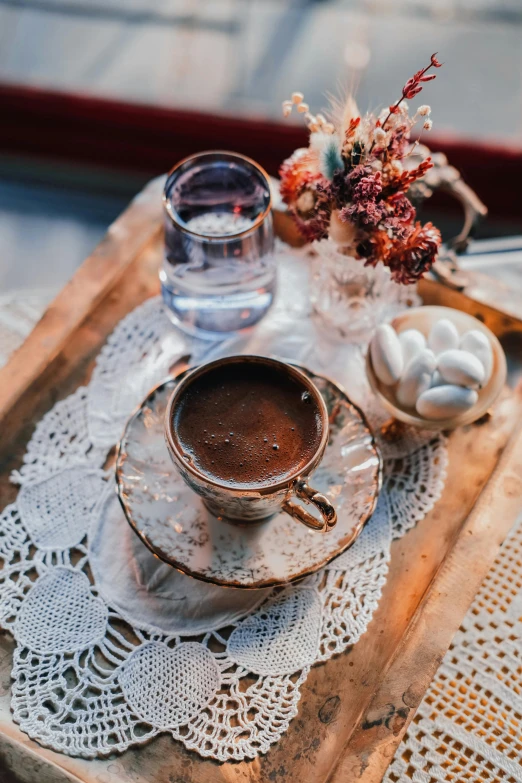 a tray that has a cup of coffee on it, by Niko Henrichon, pexels contest winner, renaissance, mixture turkish and russian, wedding, sitting on a mocha-colored table, rustic setting