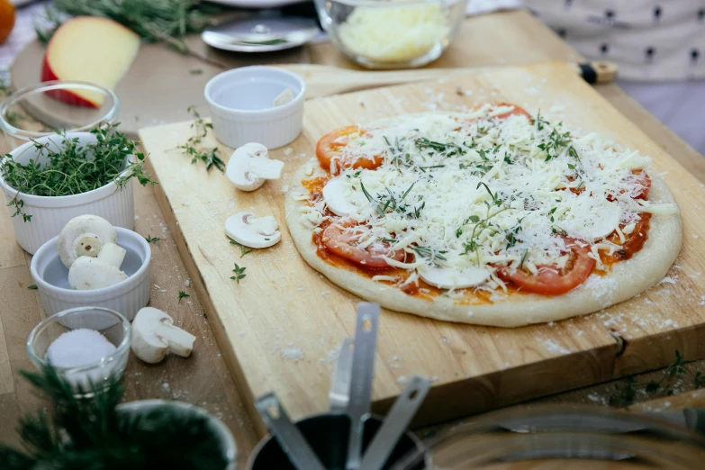 a pizza sitting on top of a wooden cutting board, pexels contest winner, process art, lots of mozzarella balls, gardening, scene from a dinner party, sparkling