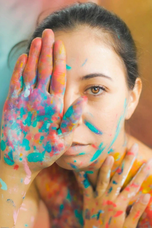 a woman covered in paint holding her hands up to her face, a photorealistic painting, inspired by artist, trending on pexels, colorful]”, vintage color, mess, intimately holding close