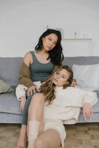 two women sitting on a couch next to each other, a portrait, inspired by Wang Duo, trending on pexels, portrait sophie mudd, neutral pose, tyler edlin and natasha tan, clothing