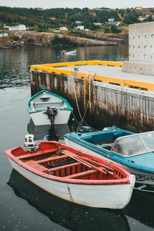 a couple of boats that are sitting in the water, colorful photograph, faroe, quebec, small dock