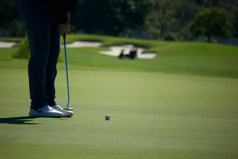 a man standing on top of a green field next to a golf ball, tournament, off - putting, unedited, taken with sony alpha 9