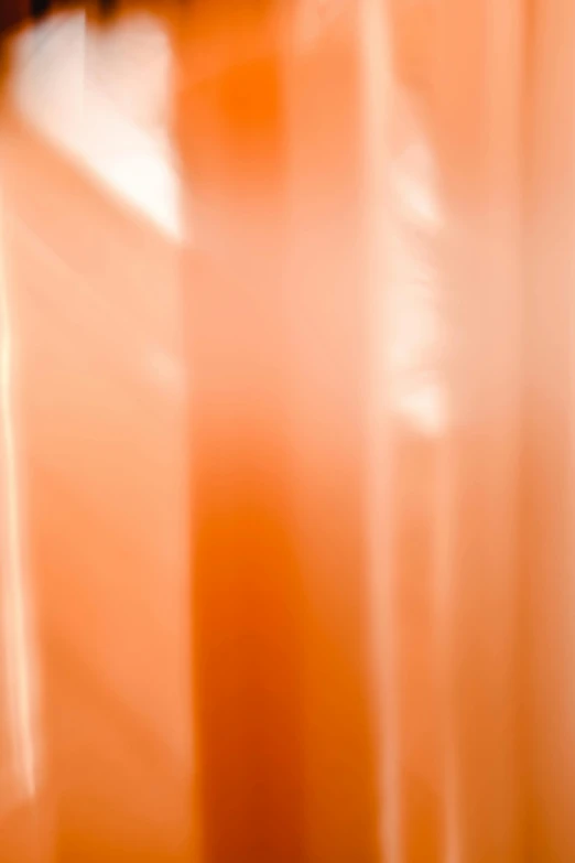 a close up of a candle with a blurry background, inspired by Christo, lyrical abstraction, flowing salmon-colored silk, glossy plastic, background made of big curtains, overexposed sunlight