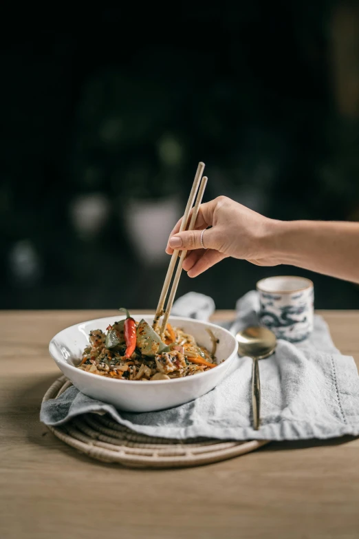 a person holding chopsticks over a bowl of food, profile image, petite, square, melbourne