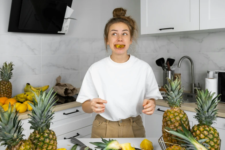 a woman standing in front of a counter filled with pineapples, by Julia Pishtar, pexels contest winner, renaissance, licking out, on kitchen table, avatar image, large gaping mouth