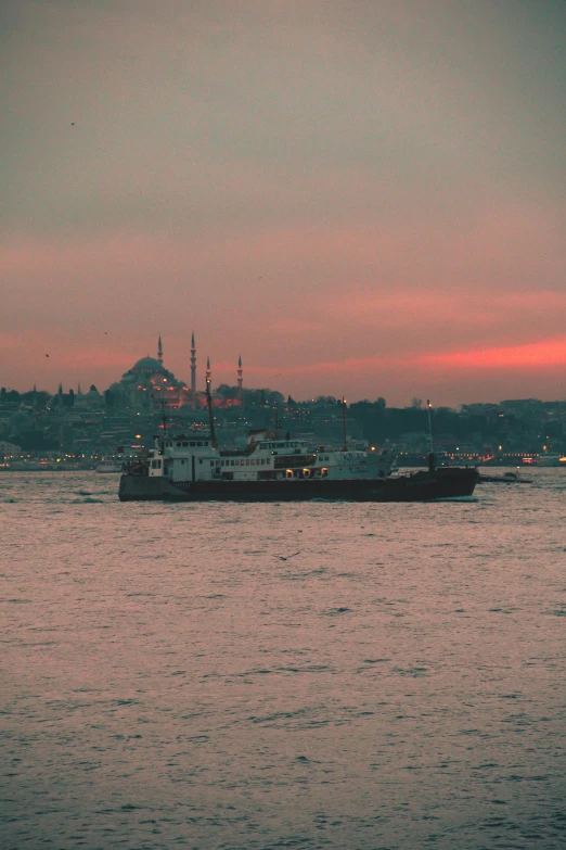 a large boat floating on top of a body of water, inspired by Elsa Bleda, flickr, hurufiyya, istanbul, 256x256, twilight skyline, slide show