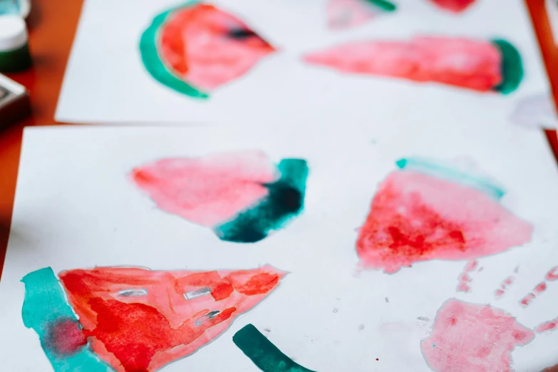 a close up of a piece of paper with watermelon painted on it, by Julia Pishtar, trending on pexels, process art, plates of fruit, children's artwork, an arcylic art, thumbnail