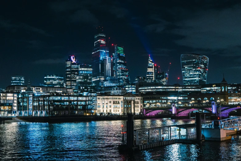 a large body of water next to a city at night, pexels contest winner, 80s london city, instagram post, night life buildings, 1 2 9 7