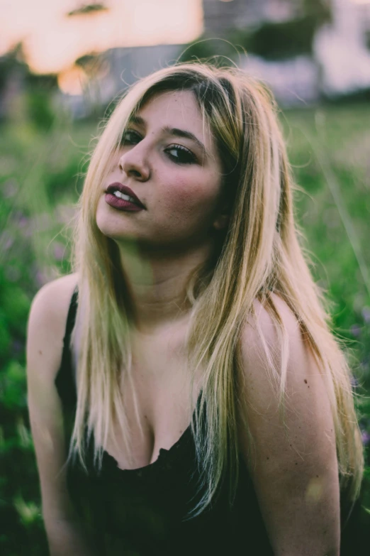 a woman sitting on top of a lush green field, an album cover, inspired by Elsa Bleda, unsplash, renaissance, dark blonde hair, violet myers, headshot profile picture, standing with a black background