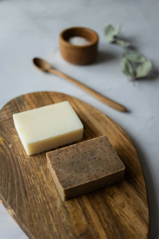 a piece of soap sitting on top of a wooden cutting board, a portrait, by Jessie Algie, unsplash, renaissance, square, tea, various posed, brown