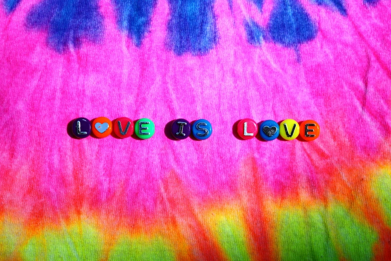 a tie dye shirt with the word love spelled on it, an album cover, pexels, beads, greg hildebrant, judy chicago, this is it style