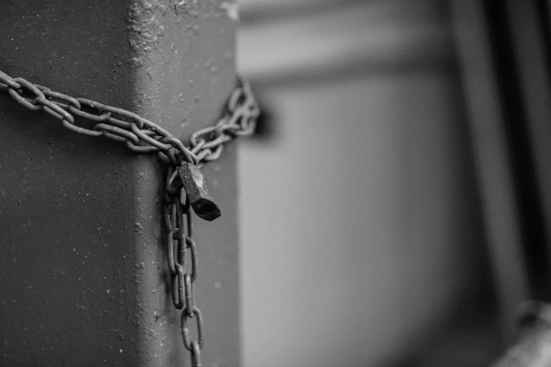 a black and white photo of a chain attached to a pole, by Matija Jama, pexels, graffiti, iron gate door texture, blockchain vault, the key of life, cracked