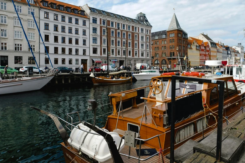 a number of boats in a body of water near buildings, a photo, by Christen Dalsgaard, hurufiyya, square, thumbnail, port, brown