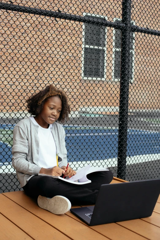 a woman sitting on the ground with a laptop, a portrait, by Gavin Hamilton, pexels contest winner, graffiti, school courtyard, a girl playing tennis, black teenage girl, sitting on bench